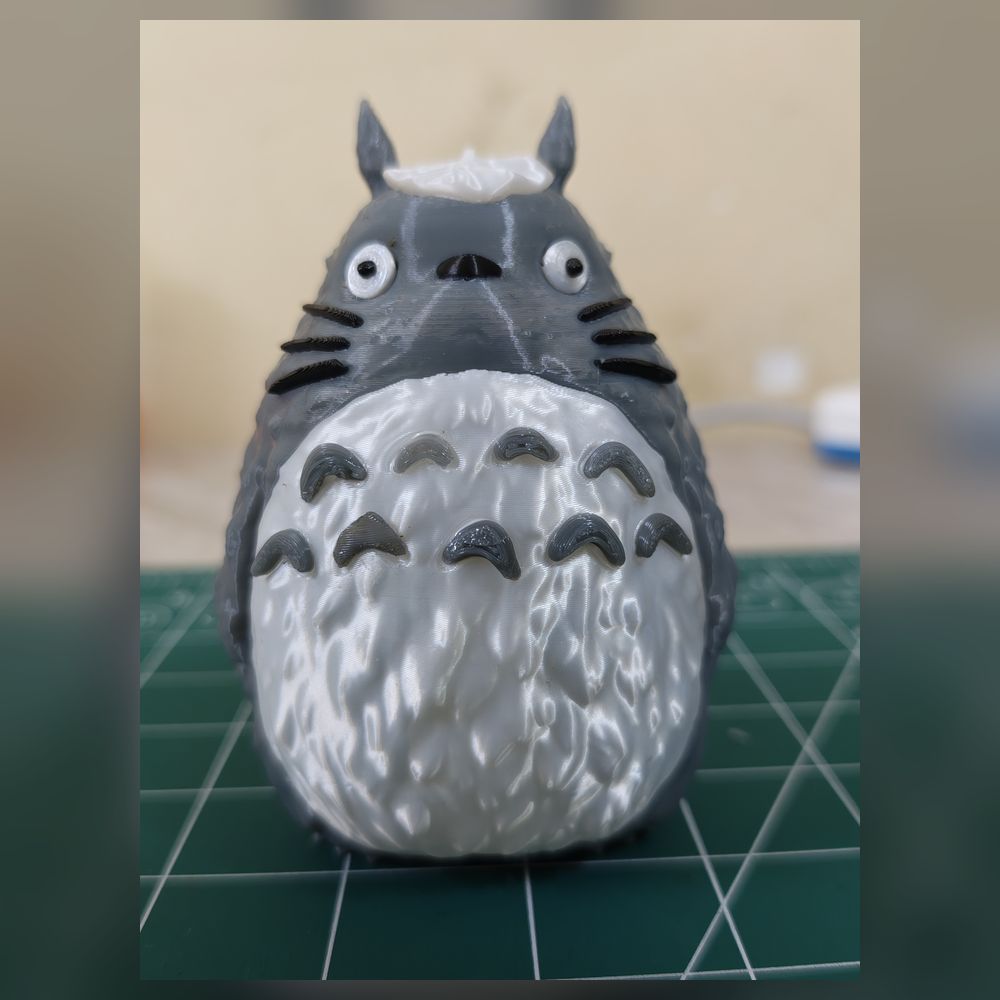 A hand-painted grey and white Totoro figurine